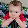baby, child, infant, playpen, red_shirt, face, arms, indoor, patterned_fabric, geometric_pattern, expressionless, resting, closeup, skin, hair, person, young_child, furniture, head, portrait