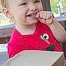 Harold joined the competition — help win amazing prizes! baby, candid, cardboard_box, cartoon_shirt, child, daylight, face, finger, head, indoors, laughing, portrait, red_shirt, seated, short_hair, smiling, table, teething, toddler, window