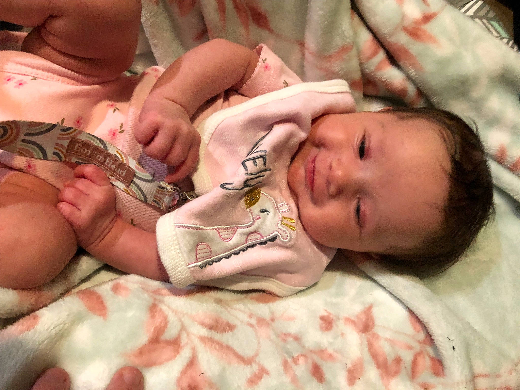 Charlotte is registered to the contest to win money with this photo: baby, baby_toddler_clothing, cheek, chest, child, comfort, eye, eyelash, facial_expression, human_leg, linens, mouth, muscle, nail, nose, person, pink, skin, thumb, toddler