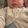 baby, child, face, person, cardigan, clothing, striped_shirt, closeup, indoors, curious, cute, infant, portrait, skin, eyelashes, nose, mouth, head, button, sitting