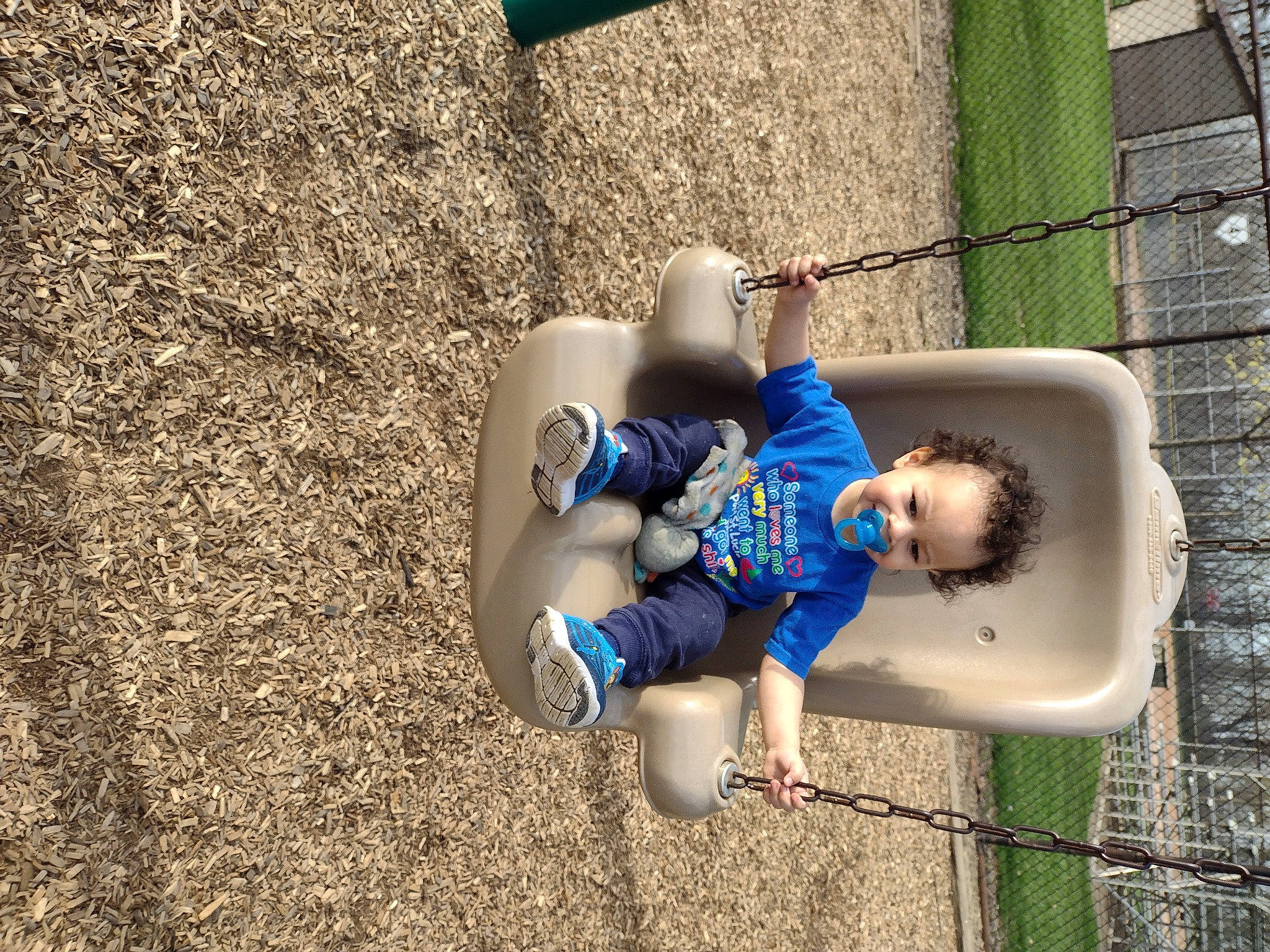 Jaylen is registered to the contest to win money with this photo: baby_toddler_clothing, child, city, concrete, electric_blue, fun, grass, human_leg, leisure, outdoor_play_equipment, person, plant, play, recreation, shadow, shorts, sitting, sneakers, soil, t_shirt