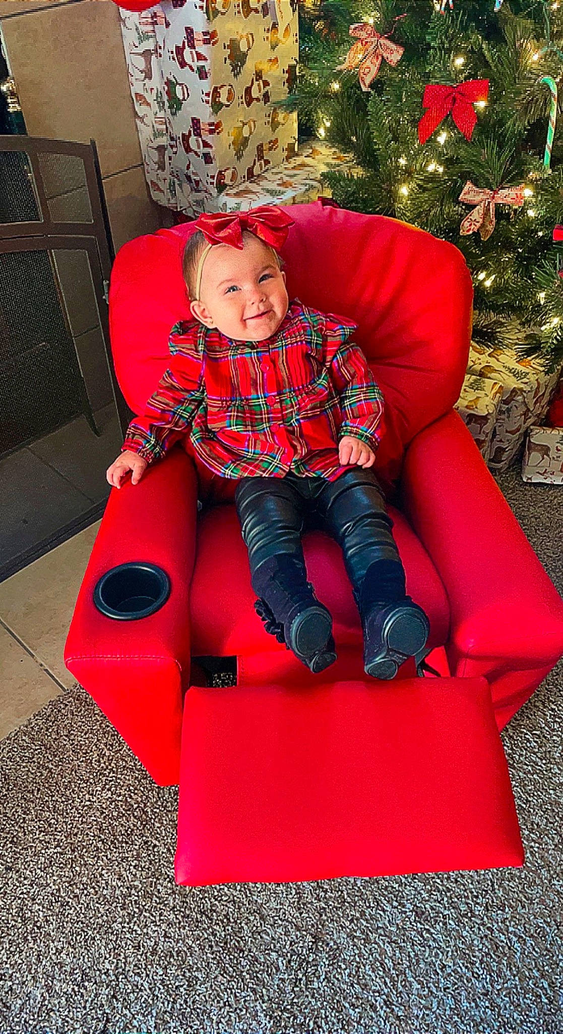Legion is registered to the contest to win money with this photo: baby_toddler_clothing, chair, child, christmas_decoration, christmas_tree, comfort, event, face, fun, furniture, head, headwear, holiday, lap, leisure, magenta, person, red, sitting, sleeve