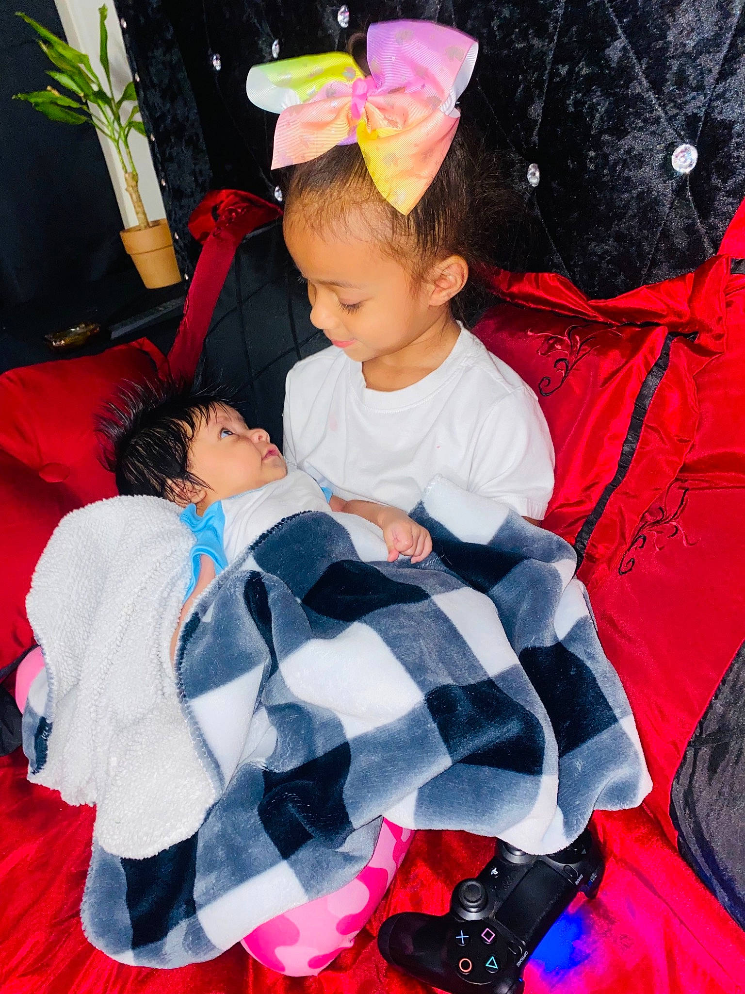 Kyra is registered to the contest to win money with this photo: baby, baby_products, baby_toddler_clothing, child, costume, event, fashion_accessory, fun, happy, leisure, linens, magenta, pattern, person, pink, plaid, plant, product, red, textile