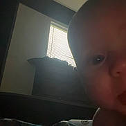 Ember joined the competition — help win amazing prizes! baby, closeup, face, tongue, indoor, window, blinds, light, shadow, curious, child, skin, head, expression, person, young, infant, room, dark, background