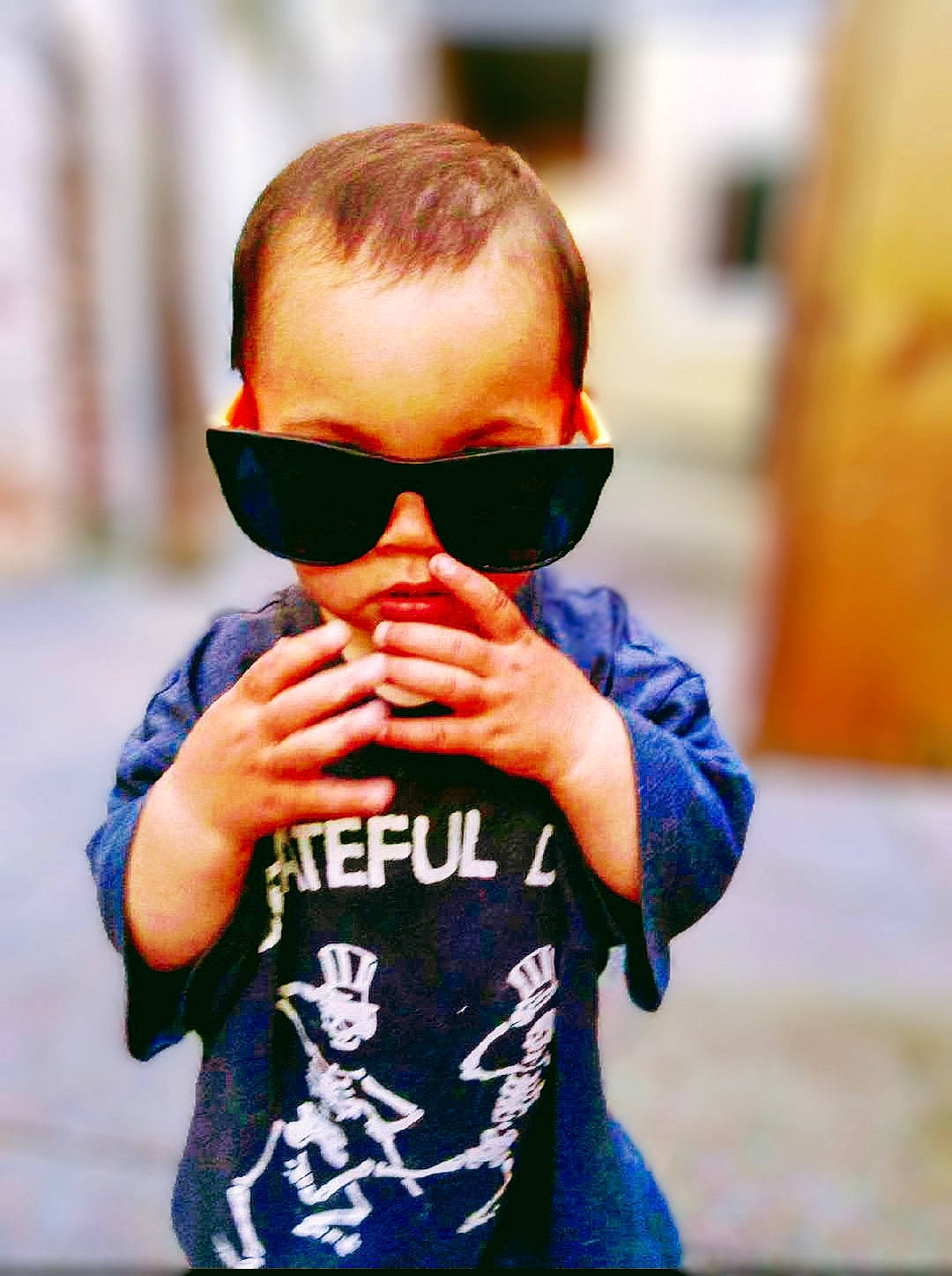Amelia Rose is registered to the contest to win money with this photo: arm, beard, child, cool, electric_blue, eyewear, finger, fun, gesture, glasses, goggles, happy, lip, orange, person, personal_protective_equipment, sleeve, sunglasses, t_shirt, toddler