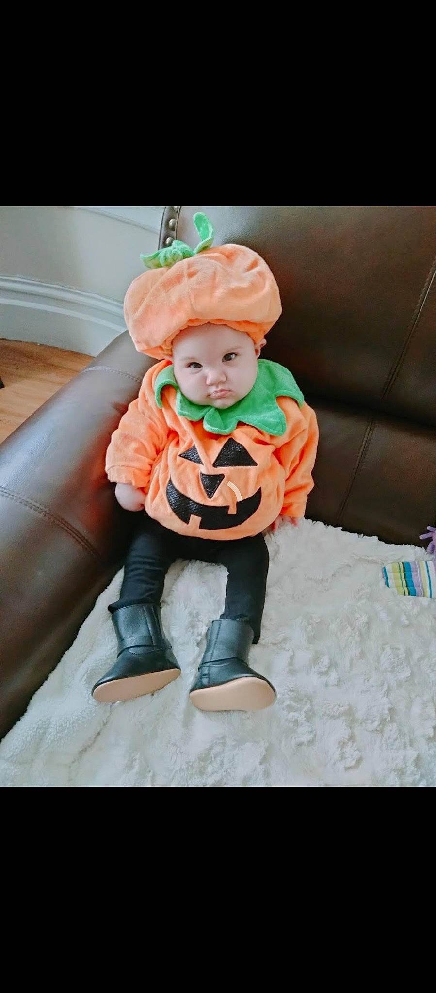 Amelia Rose joined the competition — help win amazing prizes! baby, baby_products, baby_toddler_clothing, beanie, chair, comfort, costume, couch, fashion_accessory, fictional_character, fur, headwear, linens, orange, peach, person, room, sitting, sleeve, sock