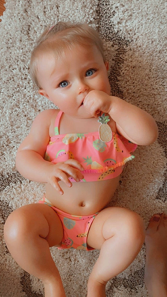 Evelynn joined the competition — help win amazing prizes! abdomen, baby, baby_toddler_clothing, cheek, chest, child, finger, lip, mouth, person, pink, sitting, skin, stomach, toddler, trunk