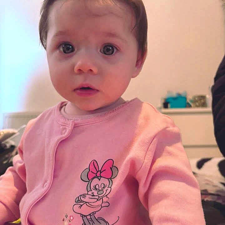 Isabella is registered to the contest to win money with this photo: baby, blonde, brownhair, clothing, coat, crawling, face, hair, head, jacket, person, photobombing, photography, portrait, sitting, skin, sleeve, spitting, t_shirt, tattoo