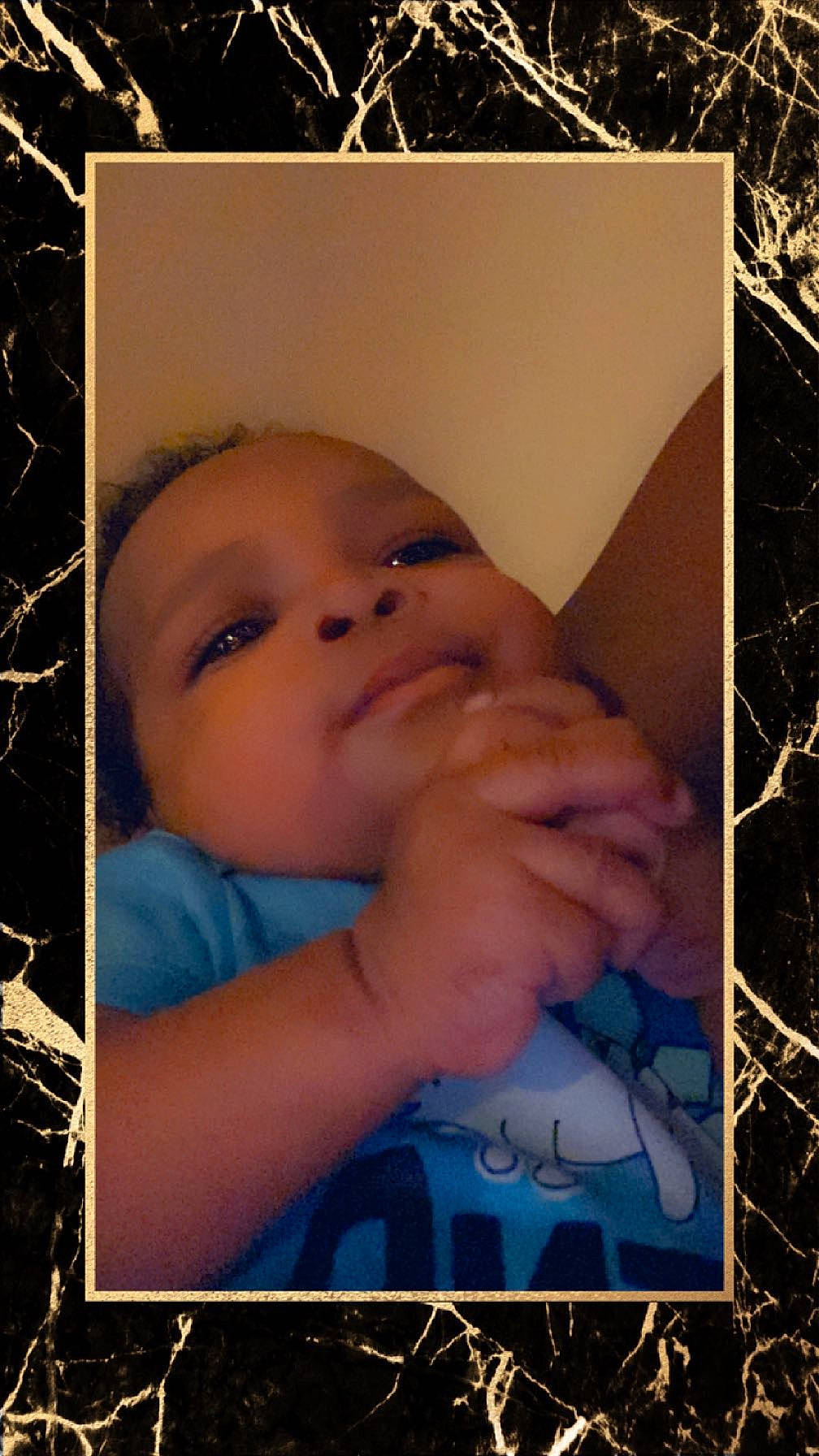 Price is registered to the contest to win money with this photo: art, baby, baby_toddler_clothing, cheek, child, eyelash, face, flash_photography, gesture, grass, happy, iris, nose, pattern, people_in_nature, person, photo_caption, skin, thumb, toddler