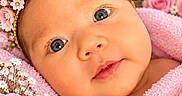 Noa is registered to the contest to win money with this photo: baby, infant, child, portrait, close_up, face, eyes, smiling, tiara, crown, pink_blanket, flowers, roses, daisies, floral, royal, wrapped, indoors, adorable, photography
