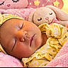 Noa is registered to the contest to win money with this photo: baby, sleeping, infant, portrait, face, closed_eyes, peaceful, blanket, pink, hearts, plush_toy, bunny, moon, stars, fairy_lights, yellow_outfit, floral, headband, cozy, nursery