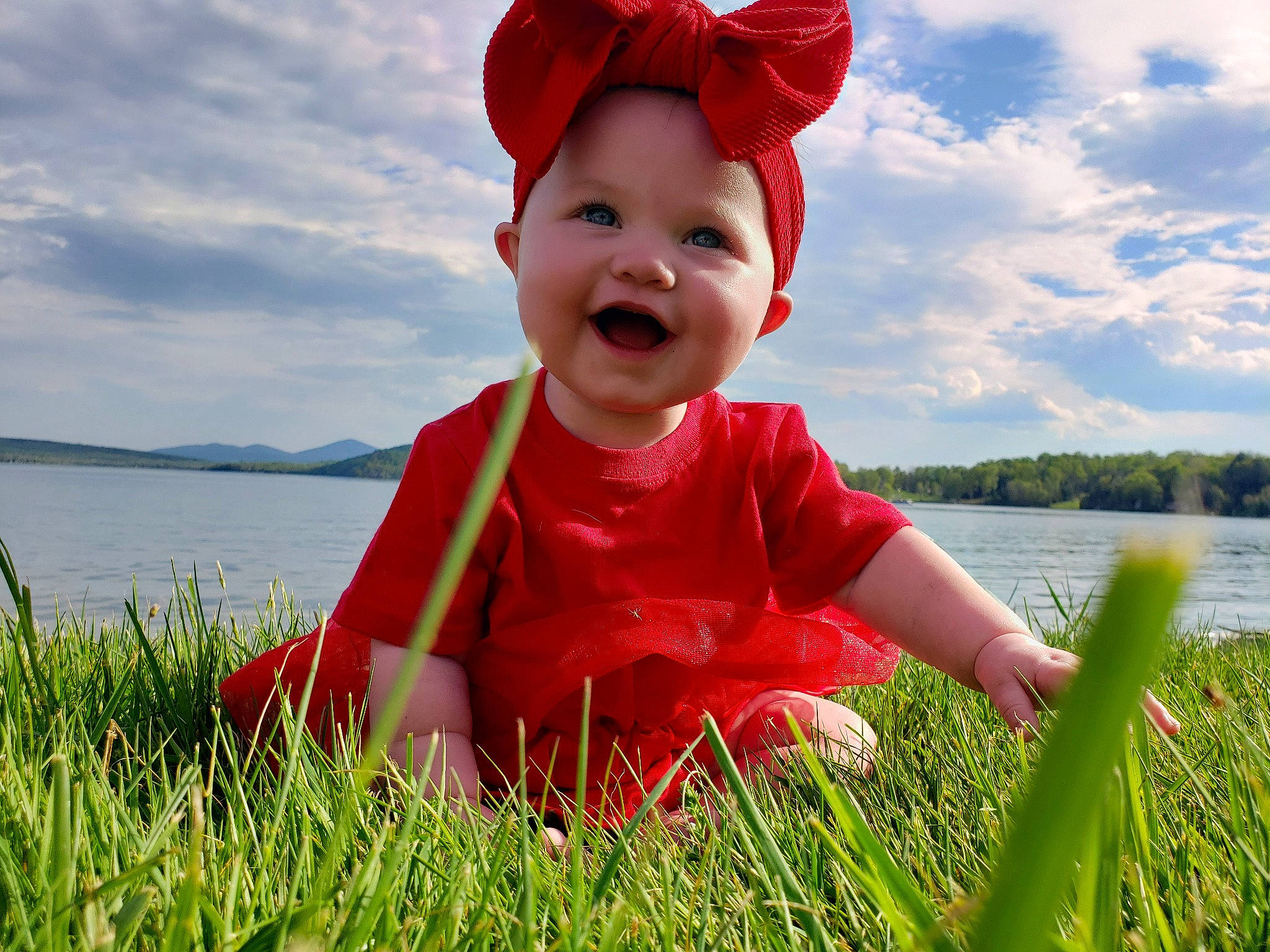 Braylynn is registered to the contest to win money with this photo: baby, baby_toddler_clothing, cap, cloud, facial_expression, grass, happy, hat, headwear, joy, light, natural_environment, people_in_nature, person, plant, skin, sky, sleeve, smile, sunlight