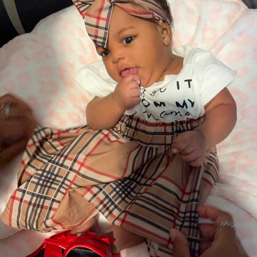 Liberty is registered to the contest to win money with this photo: baby, baseballcap, bed, blanket, bodypart, bonnet, cap, clothing, couch, cushion, face, finger, furniture, hand, hat, head, homedecor, person, photography, portrait