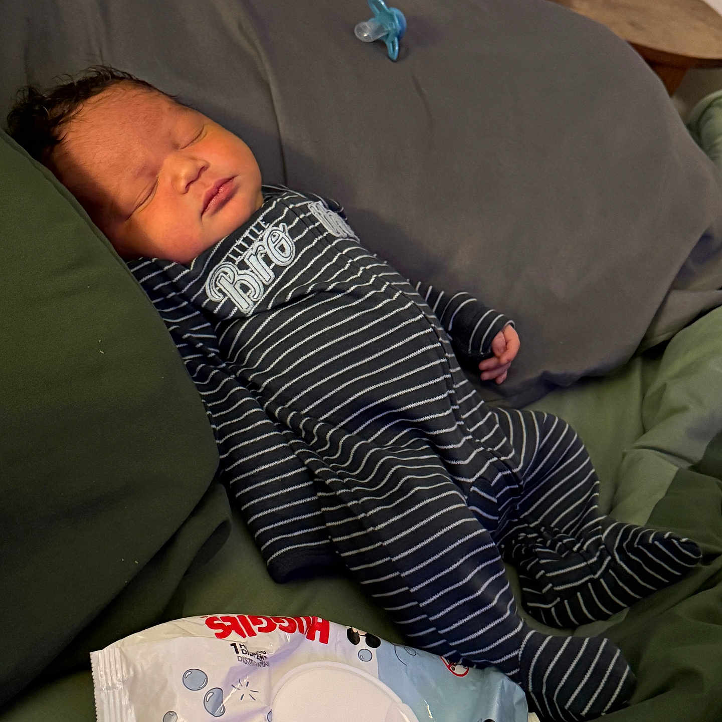 Lenoxx is registered to the contest to win money with this photo: baby, bed, child, cozy, cute, huggies_wipes, indoor, infant, newborn, onesie, pacifier, peaceful, person, pillow, resting, sleeping, soft_lighting, striped_clothing, toddler, young_child