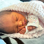 Ayali joined the competition — help win amazing prizes! newborn, baby, sleeping, blanket, pink, cozy, infant, face, hand, soft, cute, clothing, floral_pattern, wrapped, resting, peaceful, closeup, indoors, tiny, portrait