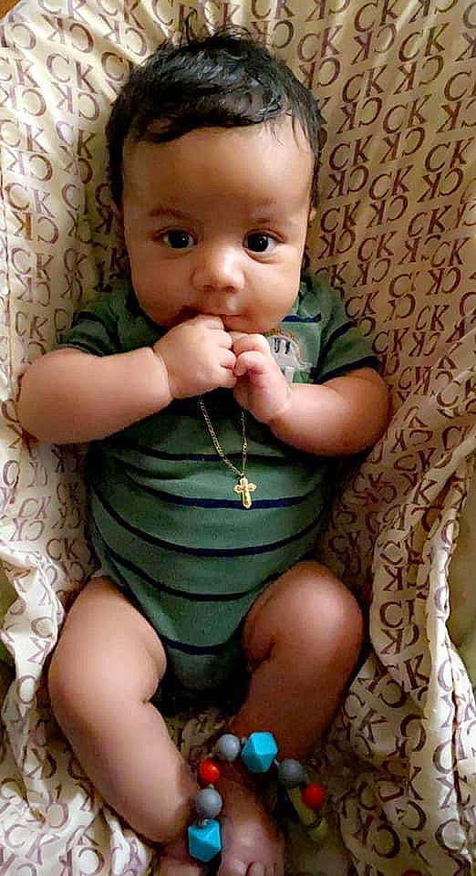 Titan is registered to the contest to win money with this photo: baby_toddler_clothing, cheek, chin, eye, face, finger, hair, hand, happy, head, iris, joint, lip, mouth, nail, neck, nose, organ, person, skin