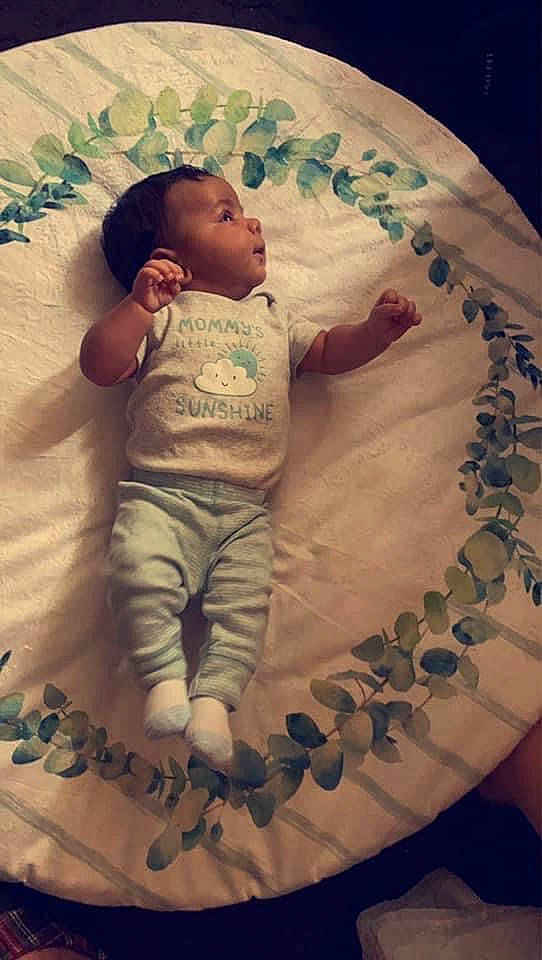 Titan is registered to the contest to win money with this photo: arm, baby, baby_toddler_clothing, child, comfort, face, finger, flash_photography, flooring, fun, hand, happy, head, linens, mouth, person, skin, sleeve, t_shirt, textile