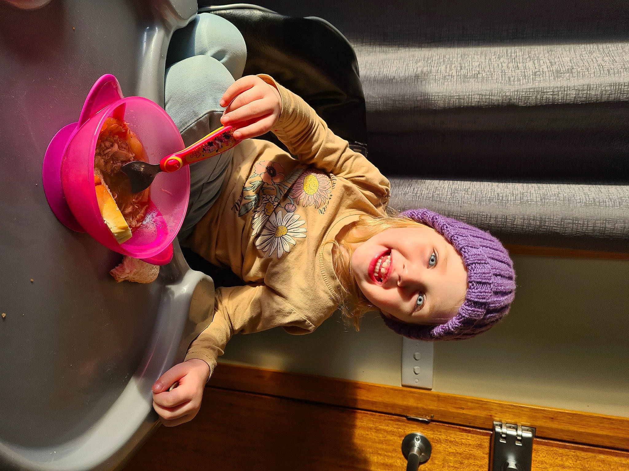 Amarni is registered to the contest to win money with this photo: baby, child, circle, food, fun, happy, headwear, leisure, magenta, person, pink, purple, room, sitting, smile, tableware, toddler, wood