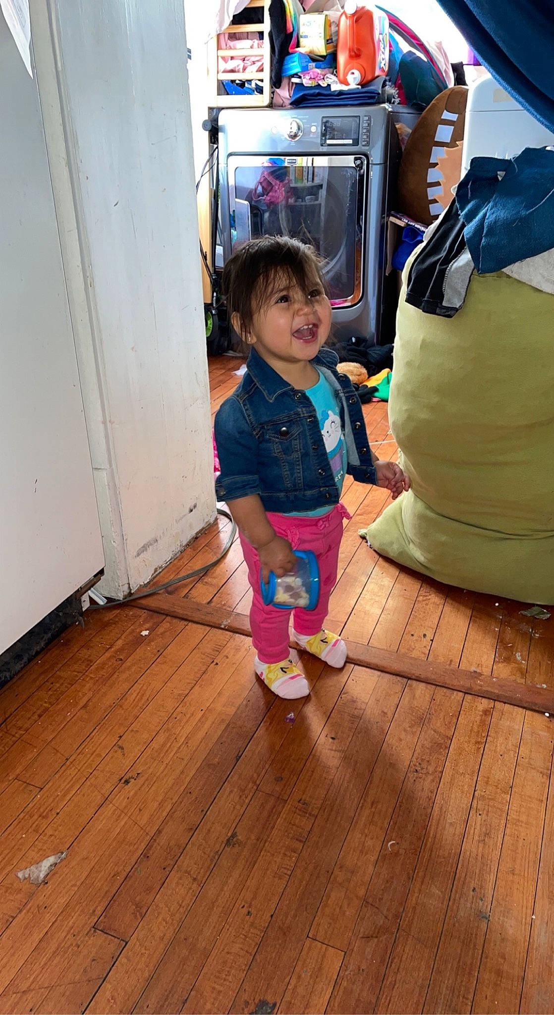 Kensi is registered to the contest to win money with this photo: backpack, child, floor, flooring, fun, happy, hardwood, laminate_flooring, leg, leisure, luggage_and_bags, person, plank, shorts, smile, sneakers, t_shirt, toddler, varnish, wood