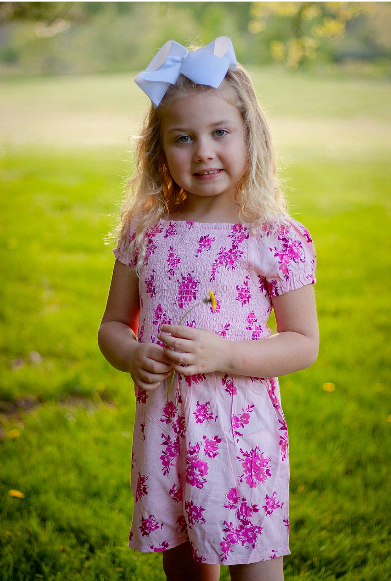 Laneya is registered to the contest to win money with this photo: baby_toddler_clothing, clothing, day_dress, dress, eye, face, fun, gesture, grass, happy, head, joy, one_piece_garment, people_in_nature, person, pink, plant, skin, sleeve, smile