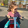 child, girl, playground, seesaw, swing, outdoor, play, happy, smile, sunlight, trees, park, casual_clothing, colorful_pants, hair_tie, daytime, fun, recreation, play_equipment, urban_park