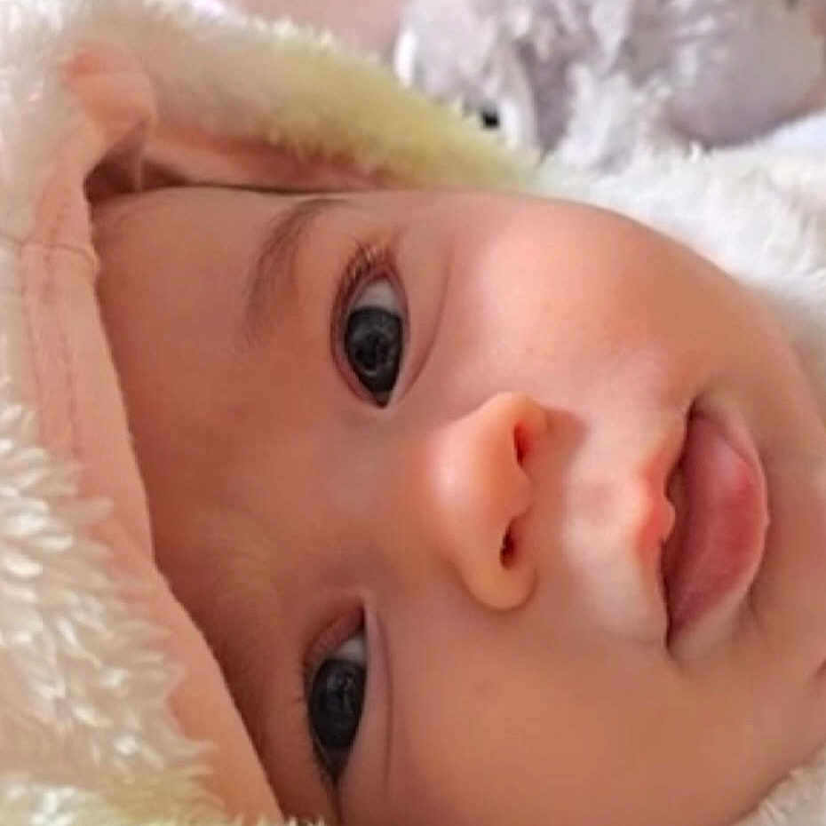 Isabella is registered to the contest to win money with this photo: baby, babylaughing, bonnet, clothing, face, happy, hat, head, newborn, person, photography, portrait, smile