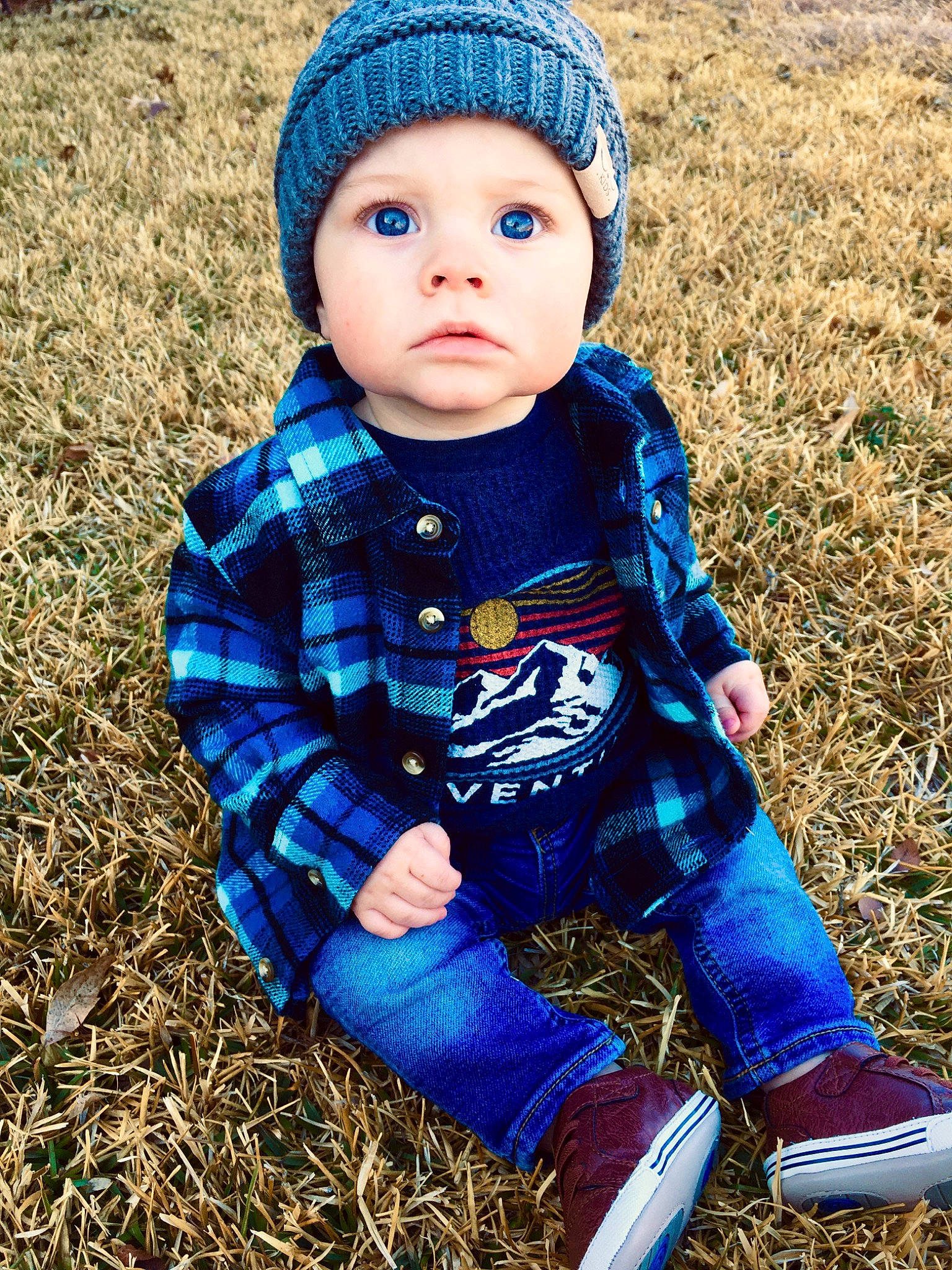 Kason joined the competition — help win amazing prizes! baby, baby_toddler_clothing, beanie, bonnet, cap, cheek, child, child_model, cool, electric_blue, fashion_accessory, grass, hat, headgear, headwear, knit_cap, outerwear, pattern, person, sitting