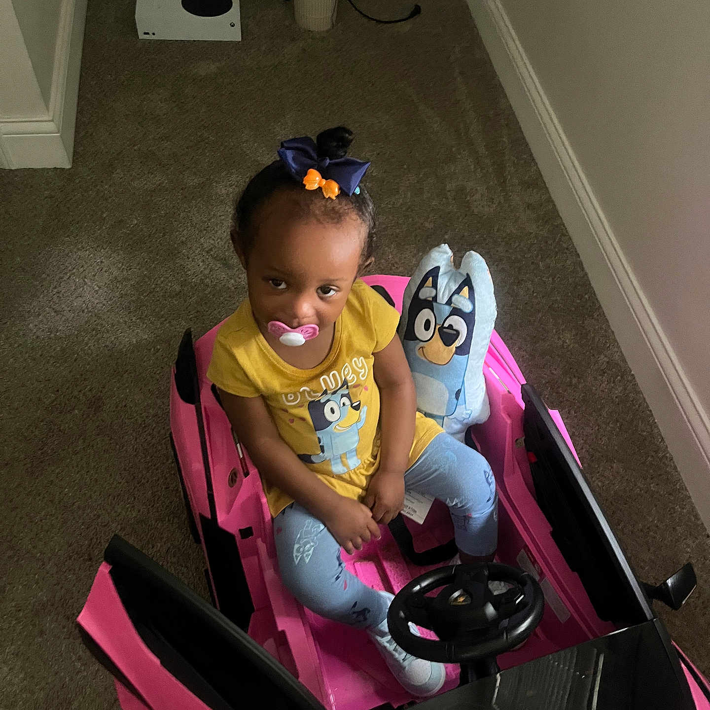 Royalty is registered to the contest to win money with this photo: child, clothing, cushion, face, female, footwear, girl, head, homedecor, machine, person, photography, portrait, purple, shoe, sitting, t_shirt, transportation, vehicle, wheel
