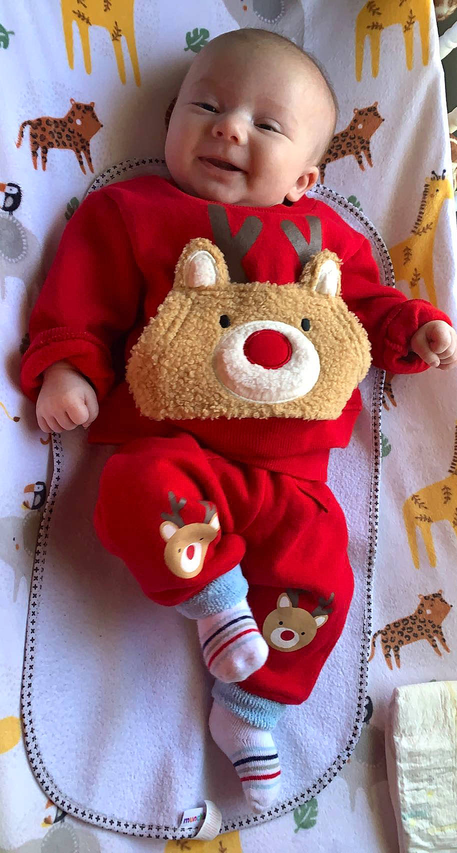 Lennox is registered to the contest to win money with this photo: baby, baby_toddler_clothing, cheek, child, happy, linens, outerwear, pattern, person, pink, plush, red, skin, sleeve, smile, stuffed_toy, teddy_bear, textile, toddler, toy