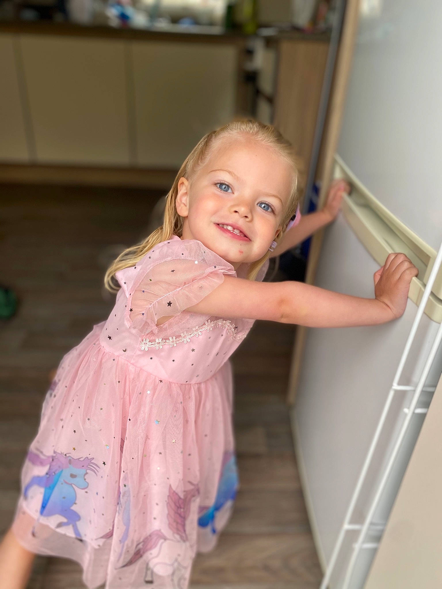 Callie is registered to the contest to win money with this photo: baby_toddler_clothing, cheek, child, dress, eye, facial_expression, floor, flooring, fun, happy, human_body, iris, joy, one_piece_garment, person, shoulder, skin, sleeve, smile, standing