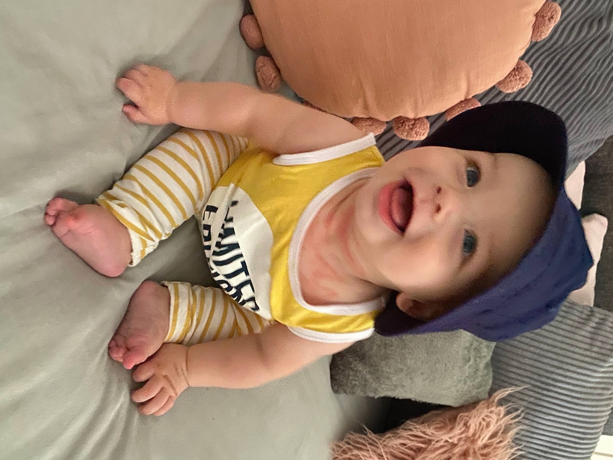 Huxley is registered to the contest to win money with this photo: baby, baby_toddler_clothing, cheek, child, comfort, eye, eyelash, facial_expression, finger, hand, headwear, human_body, leg, mouth, nail, nose, person, skin, sleeve, thigh