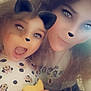 child, adult, selfie, filter, ears, nose, sparkles, cookie, bite, happy, smile, long_hair, polka_dot, clothing, indoor, face, fun, cute, playful, person