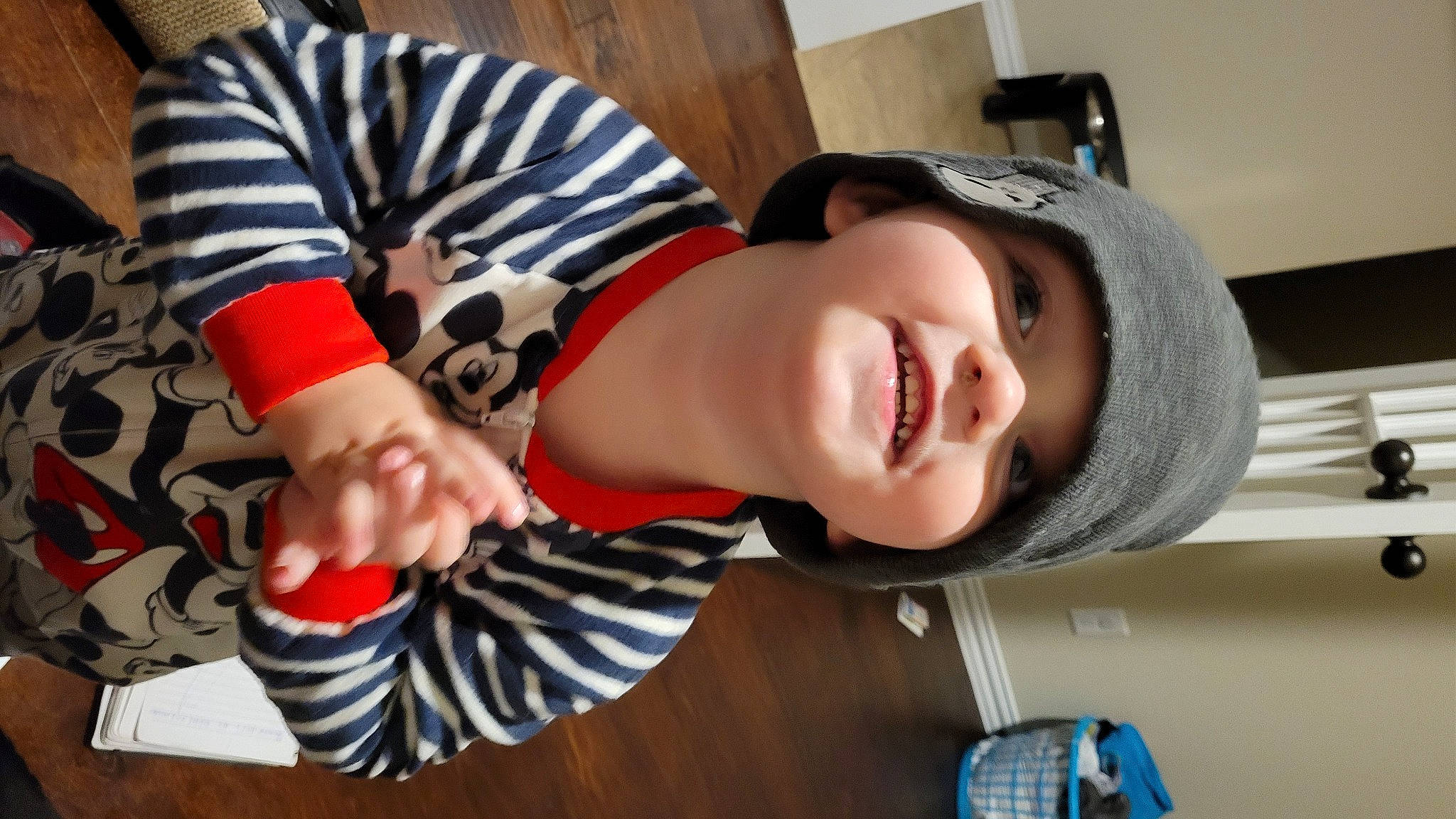 John is registered to the contest to win money with this photo: baby, bangs, beauty, blue, child, facial_expression, fashion_accessory, fun, happy, hat, headgear, headwear, human_leg, pattern, person, room, sleeve, smile, thigh, toddler