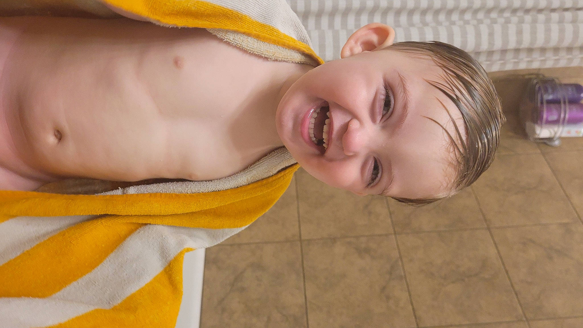 John is registered to the contest to win money with this photo: baby_toddler_clothing, cheek, child, dress, eyebrow, flooring, fun, grass, happy, human_body, iris, leisure, lip, mouth, nose, person, skin, smile, toddler, wood