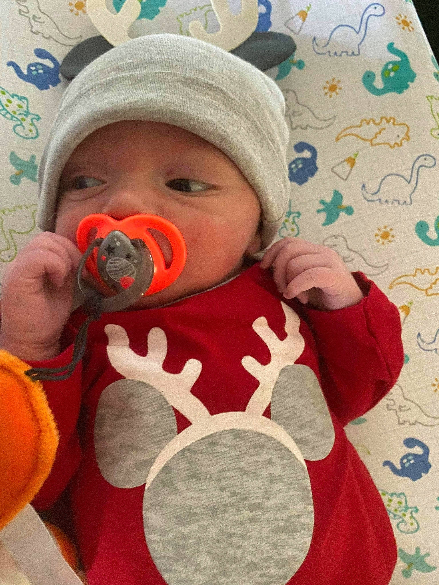 John is registered to the contest to win money with this photo: baby, baby_products, baby_toddler_clothing, cap, cheek, fictional_character, finger, happy, headgear, headwear, lip, mouth, nose, pattern, person, personal_protective_equipment, play, skin, sleeve, stuffed_toy