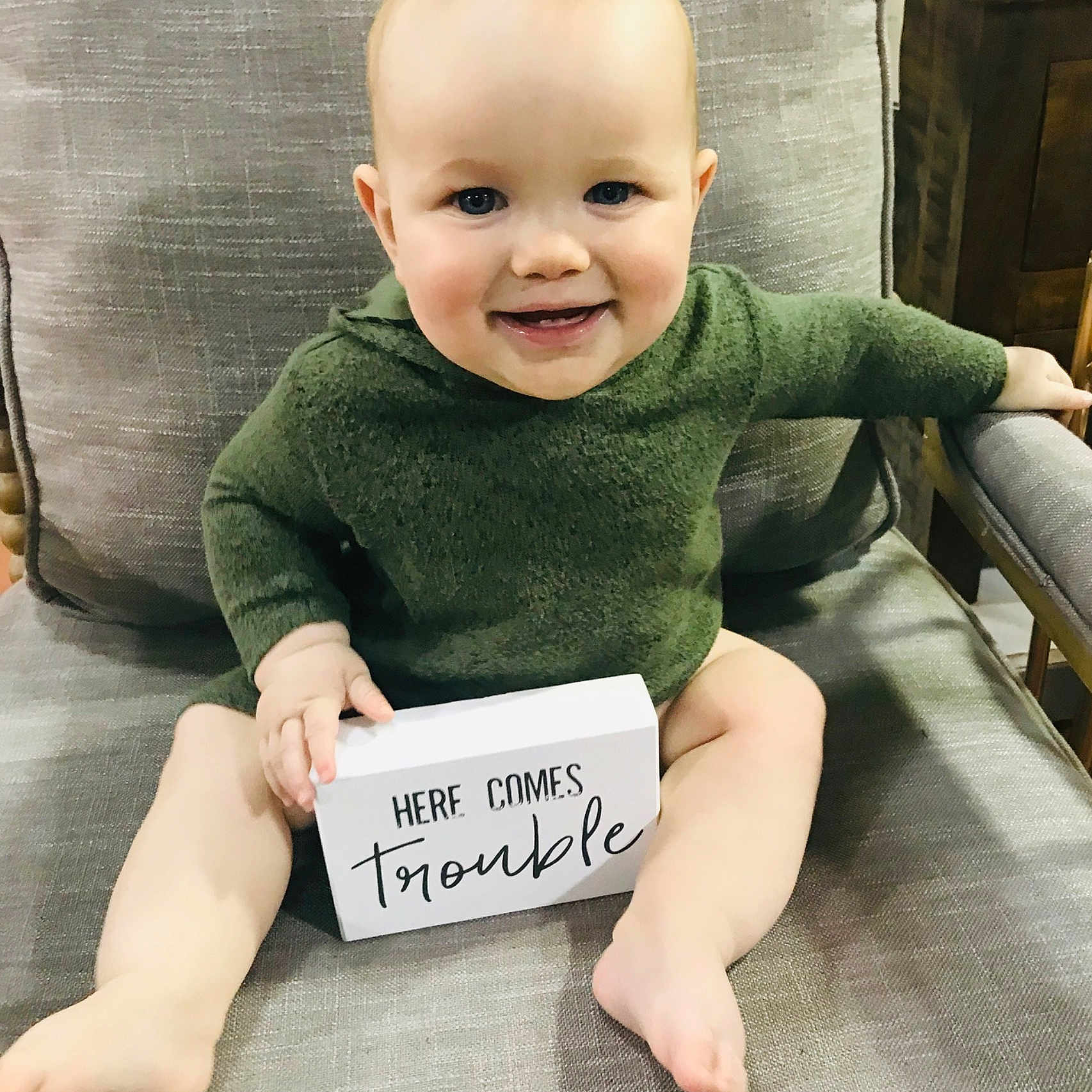 Braiden is registered to the contest to win money with this photo: arm, baby, baby_products, baby_toddler_clothing, child, face, head, joy, person, photo_caption, product, sitting, skin, smile, toddler, tummy_time