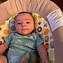 Brooks Bennett is registered to the contest to win money with this photo: baby, infant, onesie, turtle_print, baby_seat, cartoon_characters, cute, child, indoor, colorful, fabric, soft, face, person, young, playful, comfort, seat, expression, looking
