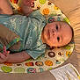 Brooks Bennett joined the competition — help win amazing prizes! baby, infant, child, onesie, turtle_print, baby_seat, colorful_pattern, bee, star, cartoon_character, plush, comfort, lying_down, indoors, hand, face, head, expression, clothing, cute
