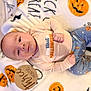 baby, infant, lying_down, blanket, pumpkin, halloween, pajamas, cute, child, smiling, face, wooden_sign, age_marker, orange, blue, white, decorations, holiday, seasonal, festive