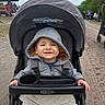 toddler, child, stroller, hoodie, blanket, smile, outdoor, path, trees, people, graco, happy, baby, person, casual_clothing, daytime, nature, park, family, transport
