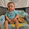 Brooks Bennett is registered to the contest to win money with this photo: baby, child, infant, couch, dinosaur, plush_toy, wooden_sign, blue_shirt, indoor, toddler, sitting, cute, smiling, face, hands, feet, blanket, home, cozy, portrait