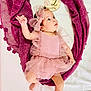Romy participe au concours pour gagner de l'argent avec cette photo : baby, infant, pink_dress, headband, milestone_sign, purple_fabric, white_background, cute, portrait, newborn, child, lying_down, tulle, celebration, two_months, small_hand, barefoot, soft_texture, adorable, looking_up