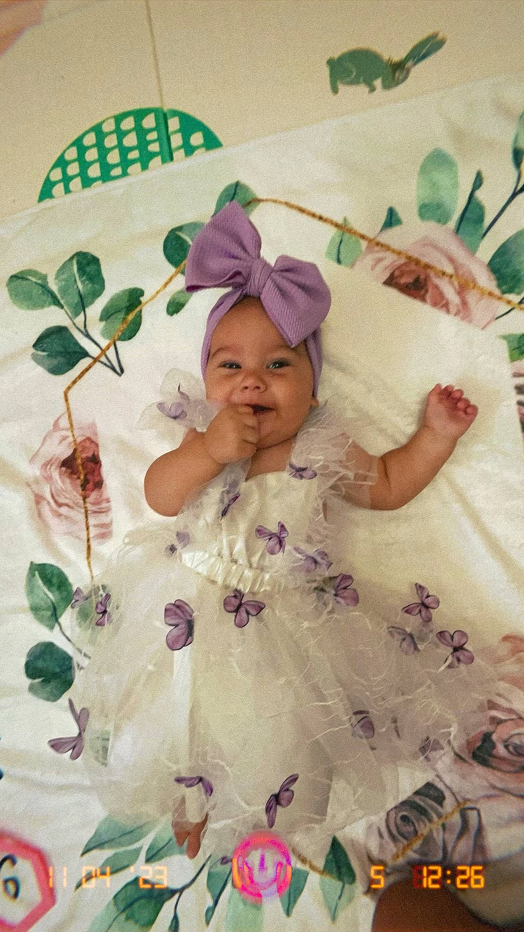Makynzi joined the competition — help win amazing prizes! baby, baby_toddler_clothing, child, event, eye, fashion_accessory, green, happy, headpiece, headwear, linens, magenta, pattern, person, petal, pink, plant, room, sleeve, smile