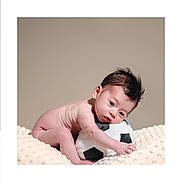 Enzo is registered to the contest to win money with this photo: adorable, baby, child, cute, hair, head, hugging, indoors, infant, lying_down, neutral_background, plush_toy, portrait, resting, skin, small, soccer_ball, soft_blanket, toddler, young