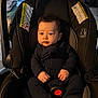 Enzo joined the competition — help win amazing prizes! baby, black, car_seat, child, clothing, cozy, cute, expression, face, furniture, hands, indoor, infant, light, looking, person, plant, portrait, seat, sitting