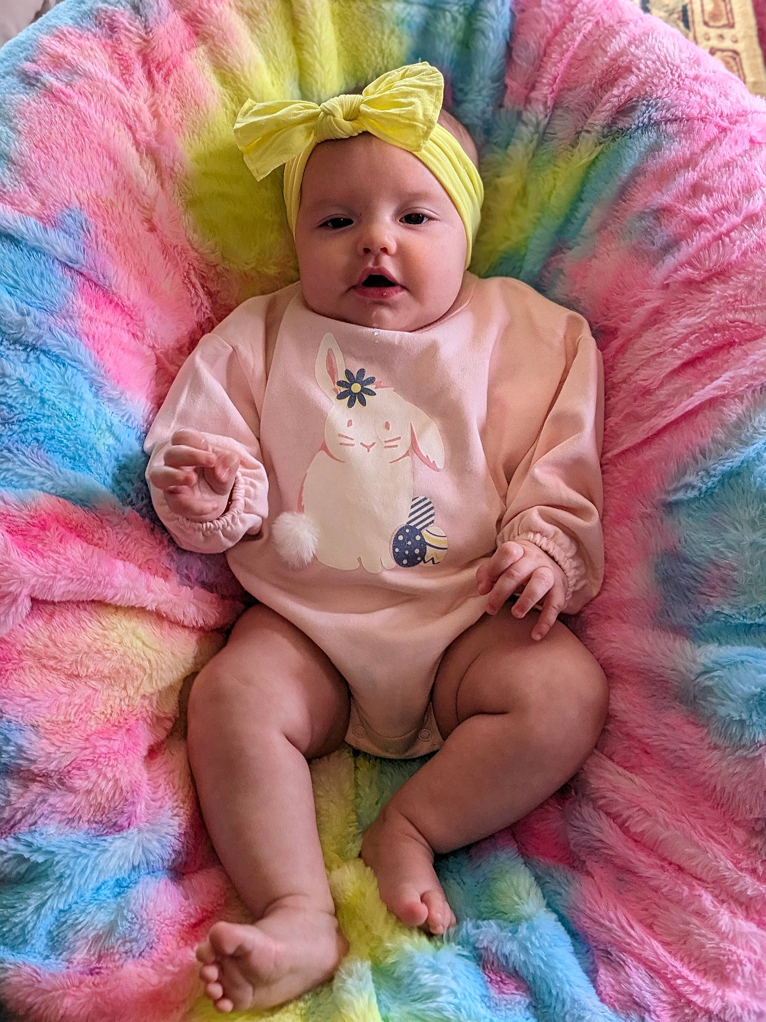 Anora is registered to the contest to win money with this photo: baby, baby_products, baby_toddler_clothing, child, costume, costume_hat, event, fashion_accessory, fun, happy, headgear, headpiece, headwear, iris, magenta, peach, person, pink, purple, sitting