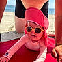 Garance a rejoint le concours — aidez-le/la à gagner de superbes lots ! baby, child, sunglasses, pink_hat, beach, sand, adult, swim_trunks, red_mat, sun_protection, crawling, summer, sunny, outdoor, person, ocean, water, skin, hand, face