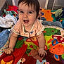 baby, child, smiling, crawling, playmat, toy, blanket, indoor, playpen, colorful, cute, happy, person, infant, clothing, soft_toy, head, face, hands, floor