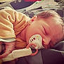 Léonie participe au concours pour gagner de l'argent avec cette photo : baby, bed, blanket, child, cozy, cute, face, hand, indoors, infant, newborn, pacifier, peaceful, plush_toy, portrait, relaxing, resting, sleeping, soft, yellow_outfit