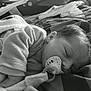baby, bed, blanket, child, clothing, comfort, cozy, cute, face, hair, indoors, infant, monochrome, pacifier, peaceful, portrait, resting, sleeping, soft_toy, young_child